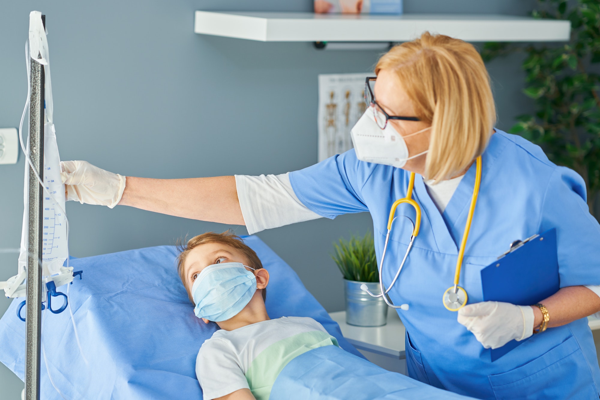 Adult woman and young patient in hospital bed