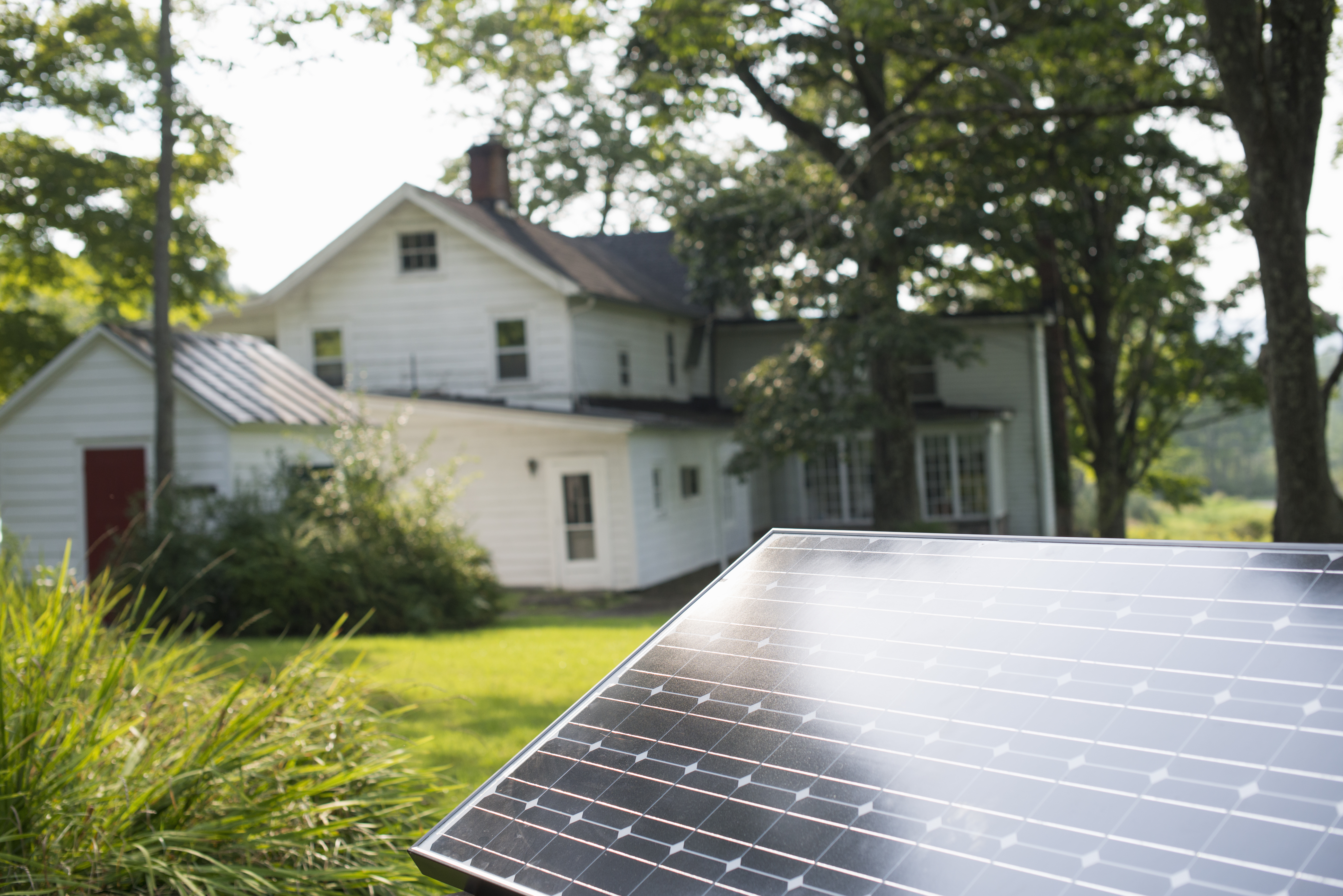 A solar panel in a farmhouse garden.