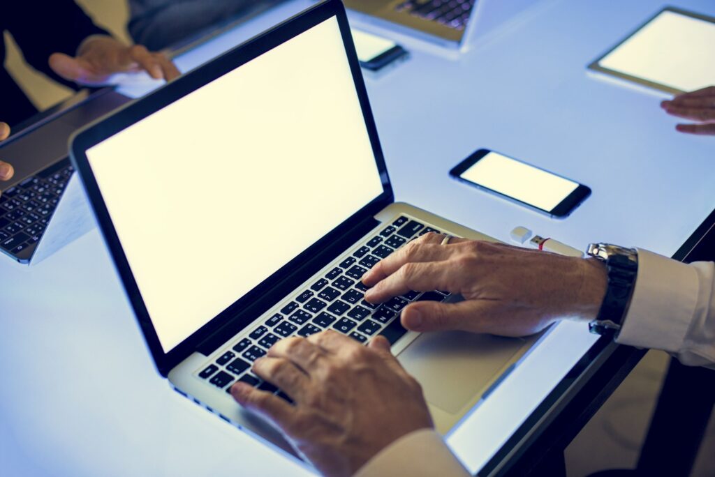 Hand on a laptop working at cyber space table